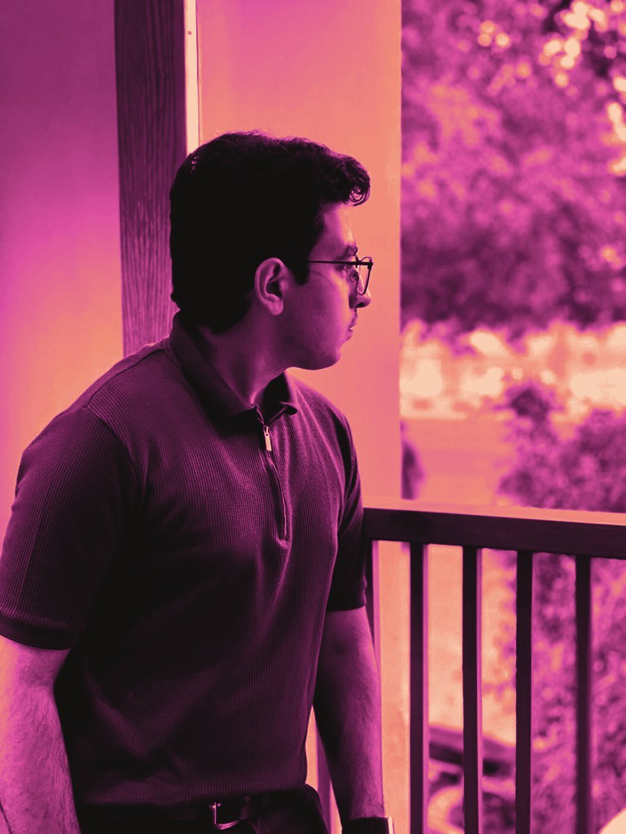 Portrait of Ahad looking out from a balcony